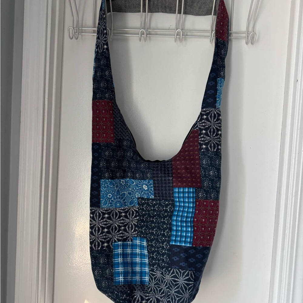 Patchwork Shoulder Bag with one outside zipper and zipper closure.
